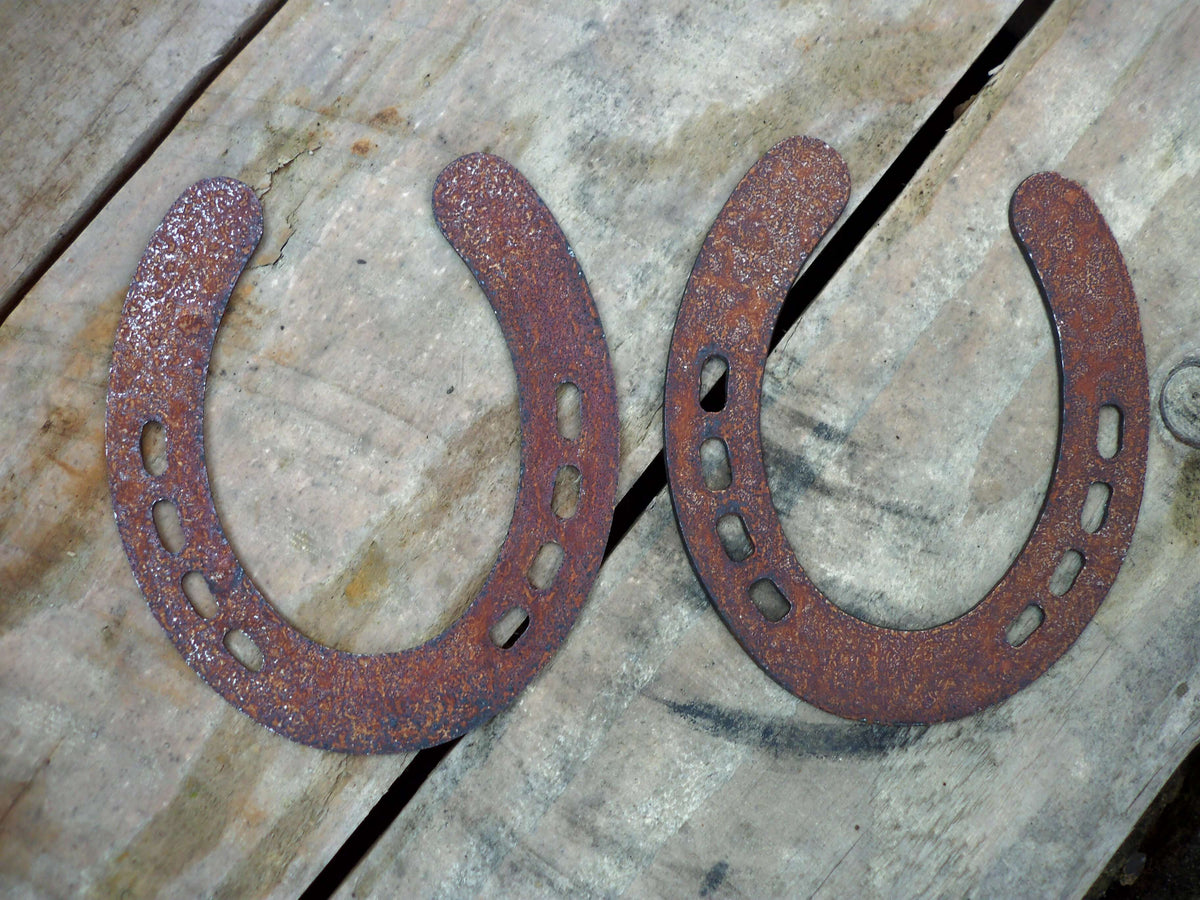 Rusty Steel PAIR OF HORSESHOES Garden Ornaments on wooden background, showcasing rustic metal garden art.