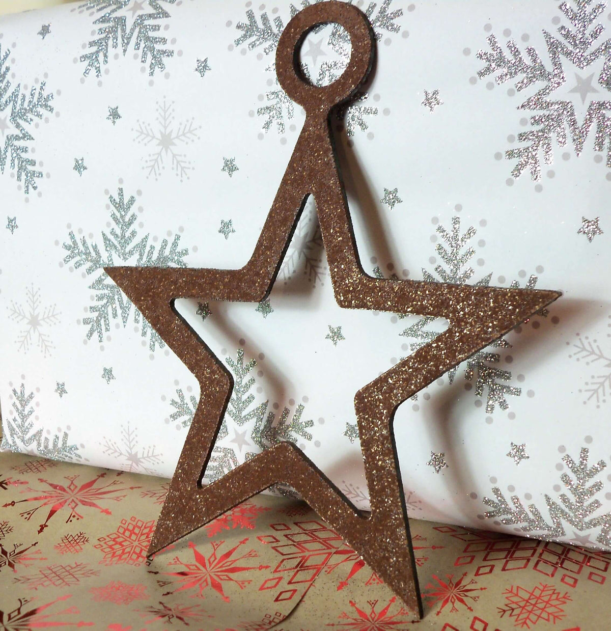 Rustic Steel Star Garden Gift Set - Rusty metal hanging star garden ornament standing beside a present