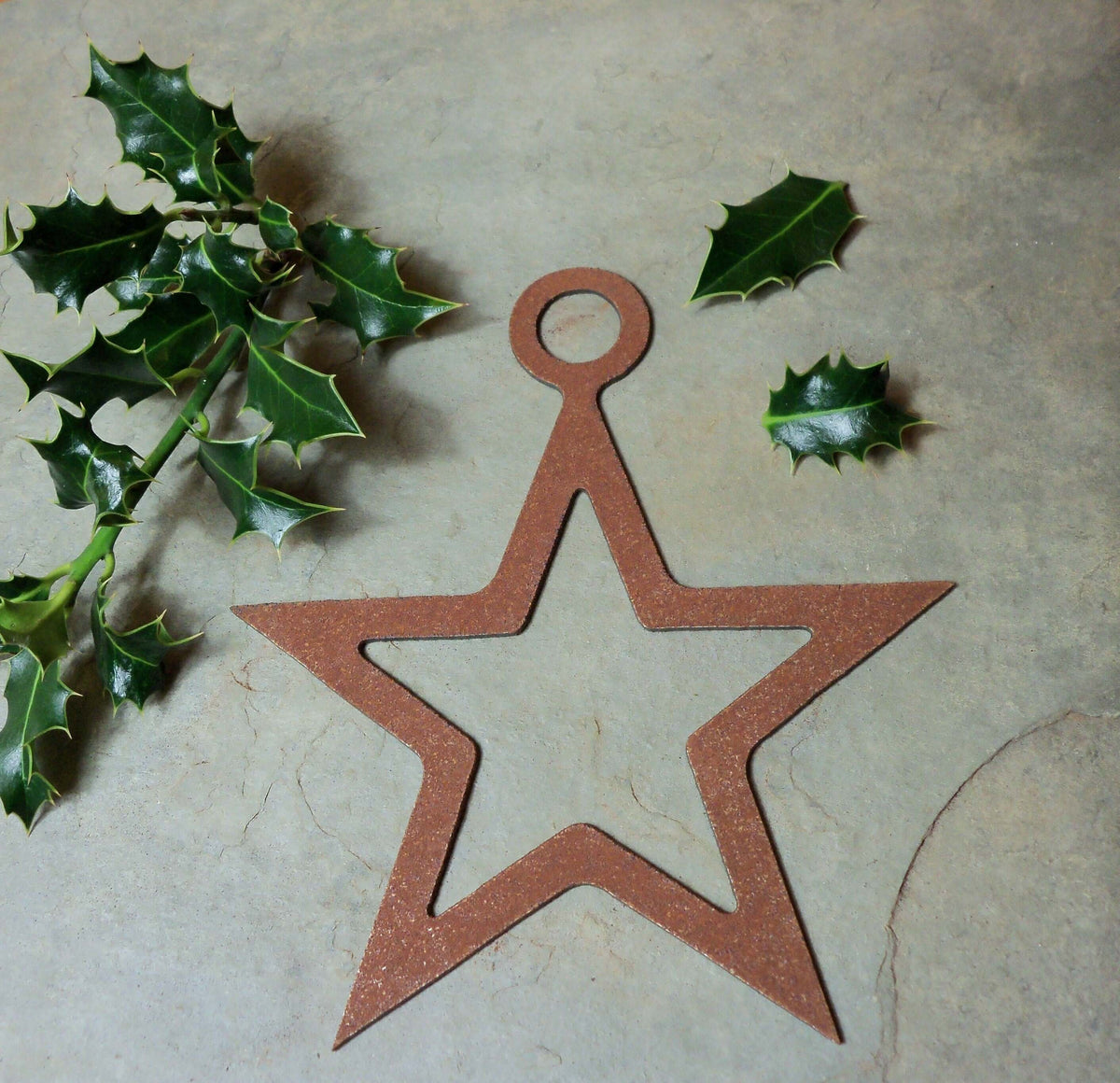 Rustic Steel Star Garden Gift Set - Rusty metal hanging star garden ornament on a grey slate with holly