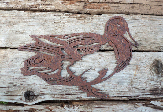 Rusted Metal Duck shape on a wooden board