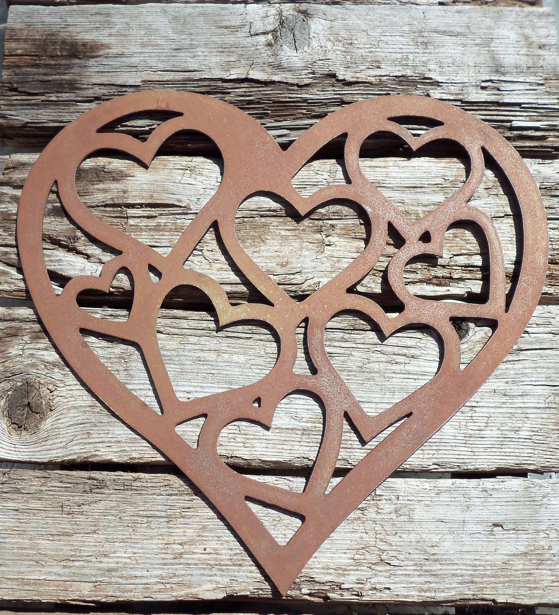 Rusty Metal LOVE HEART of HEARTS Garden Ornament displayed on wooden background.