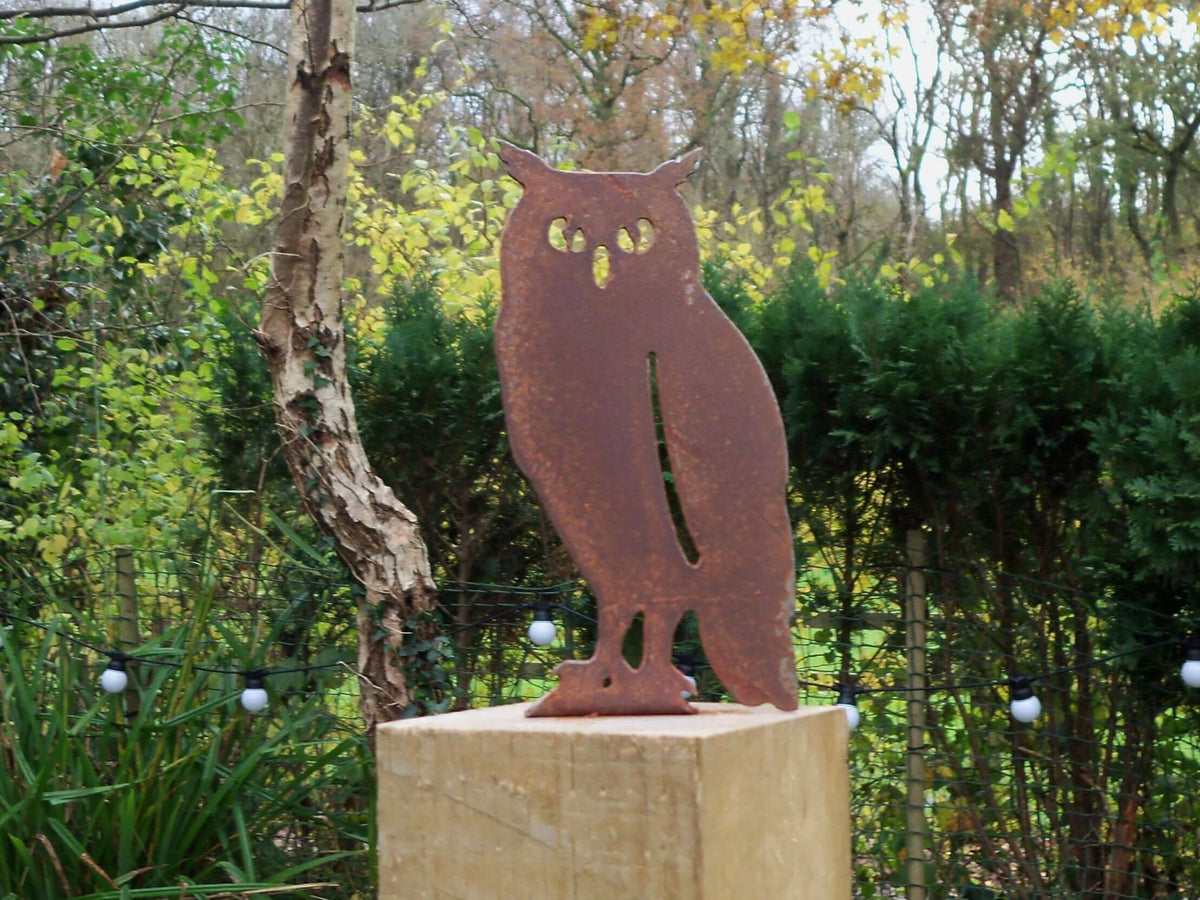 rusted steel owl garden ornament displayed in a garden setting, showcasing its unique rusted patina and handmade design.
