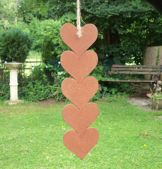 Rusty metal hanging hearts garden ornament featuring five hearts with jute string for rustic garden decor.