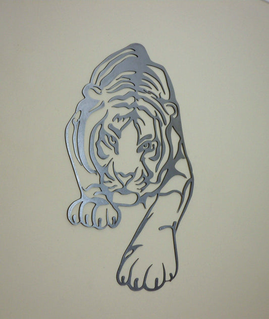 Decorative metal tiger wall art hanging on a neutral beige wall