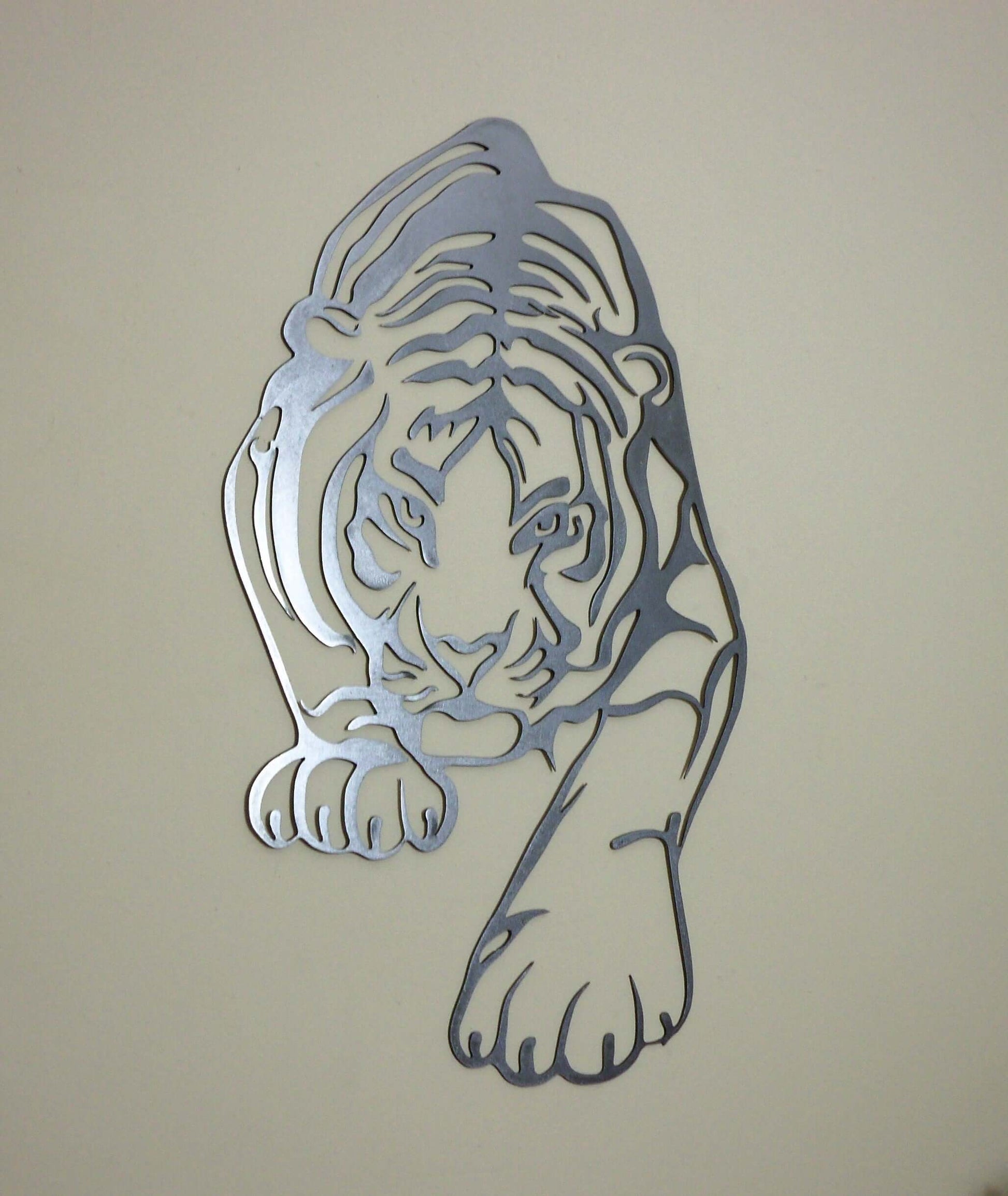 Wildlife-inspired metal tiger wall art centerpiece on beige wall