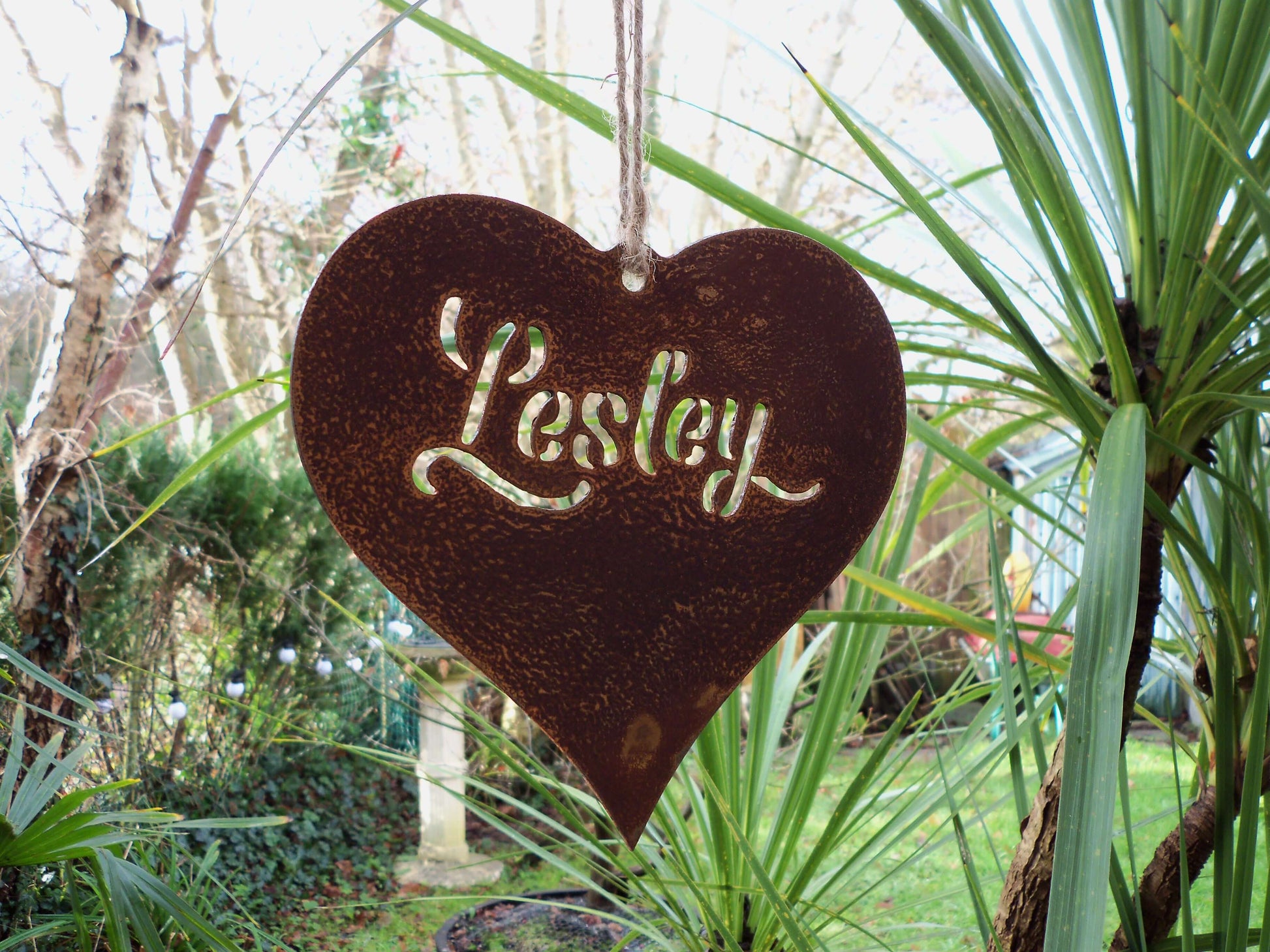 Personalised rusty metal hanging heart ornament in memorial garden
