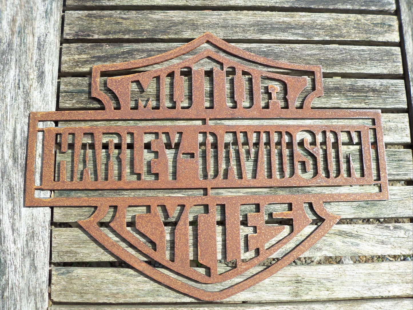 Rustic Metal Harley Davidson Motorcycle Badge Sign on a wooden background