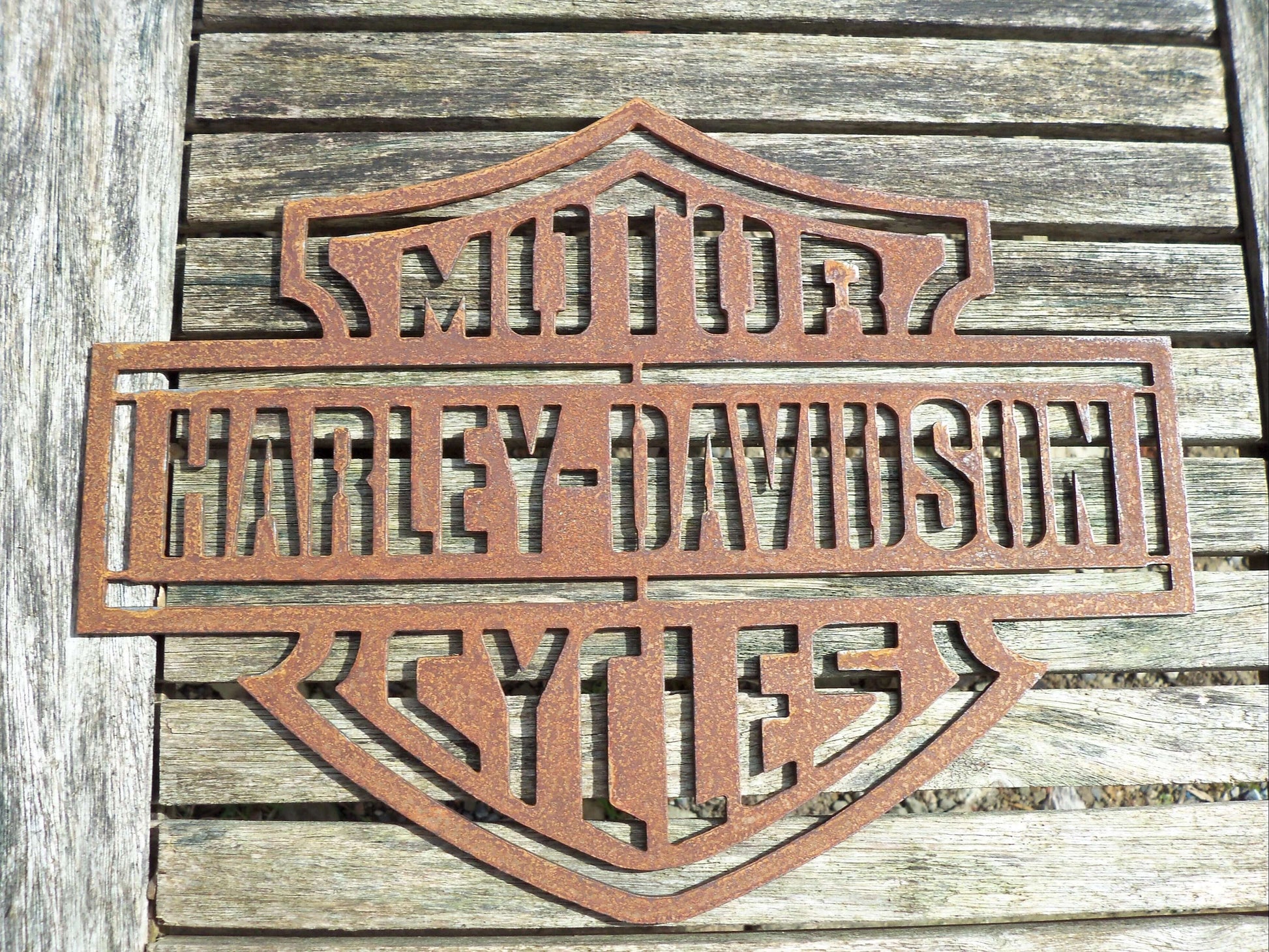 Rustic Metal Harley Davidson Motorcycle Badge Sign on a wooden background