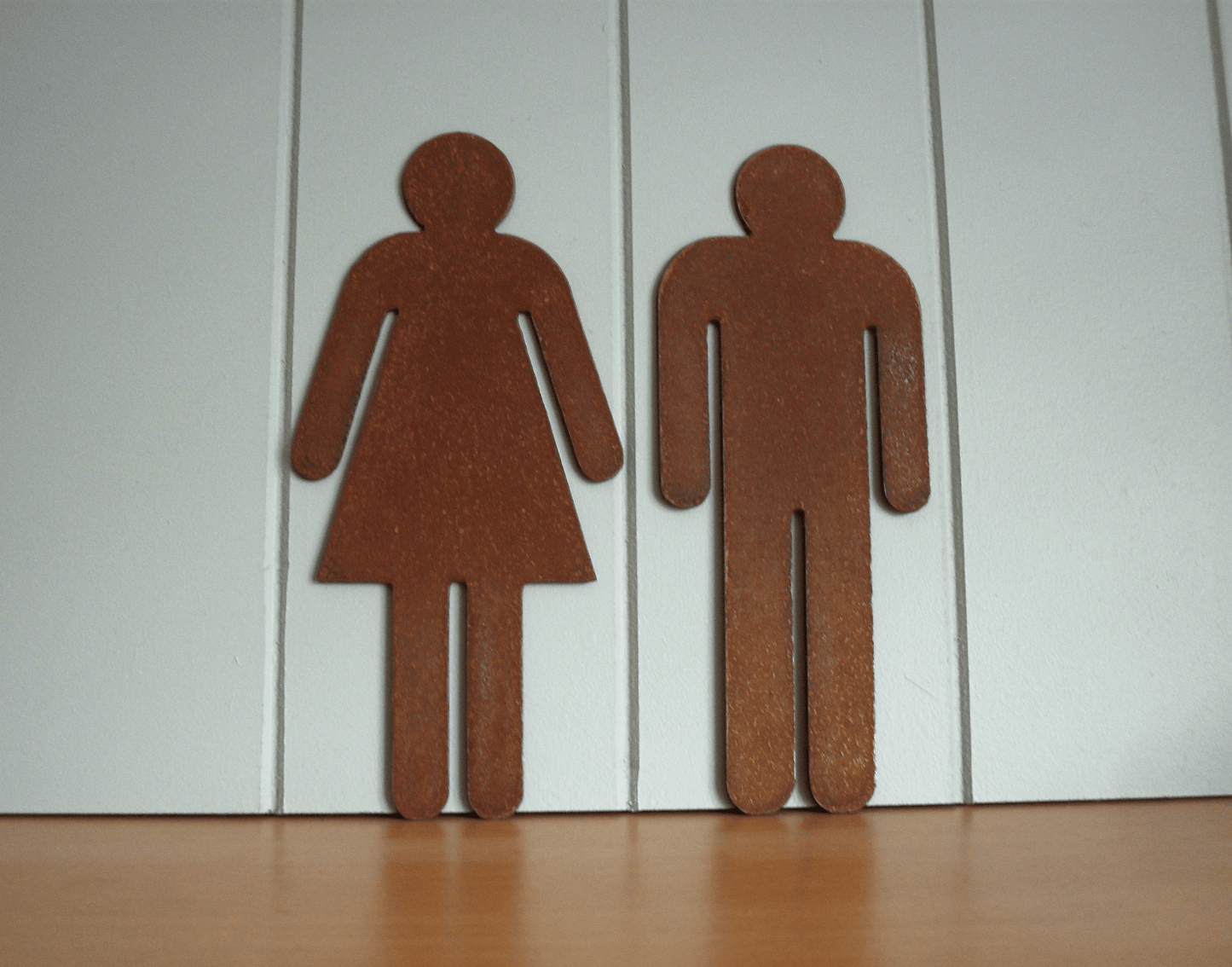 Rustic Metal WC Toilet Door Signs - Brown male and female restroom signs on a white wall.