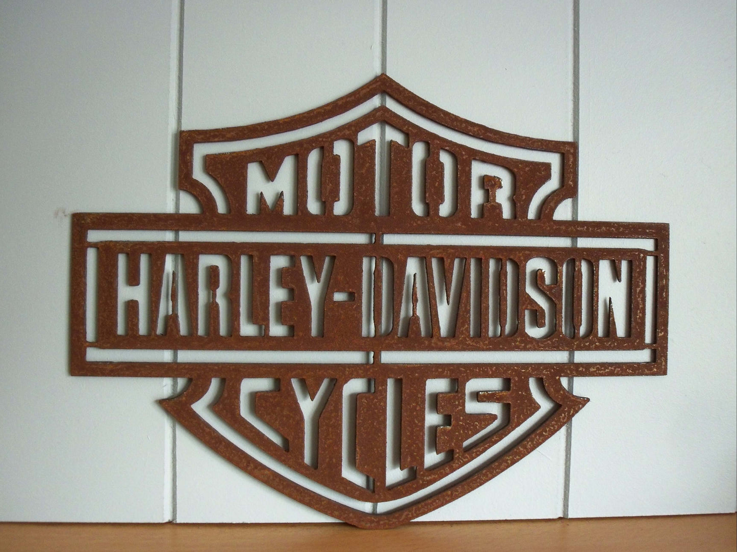 Rustic Metal Harley Davidson Motorcycle Badge Sign on a tiled wall