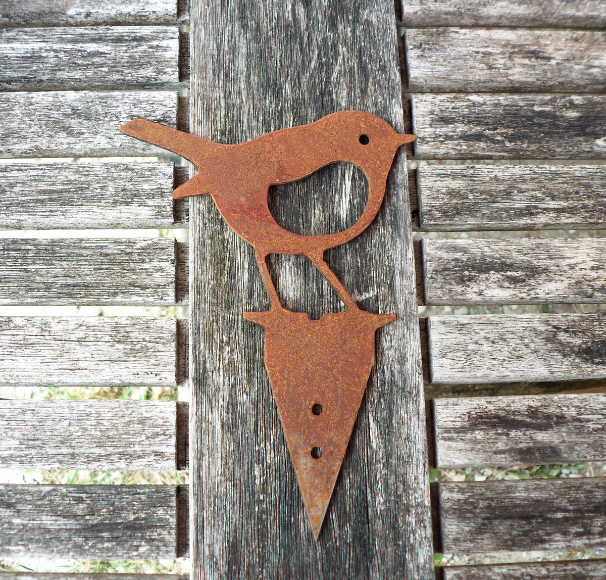 Rusty Steel Robin Garden Ornament displayed on wooden table, featuring a rustic metal bird design for garden decor.