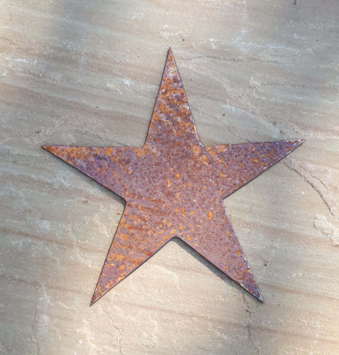 Rustic Steel Star Garden Gift Set - Rusted metal large star garden ornament on a beige stone background 