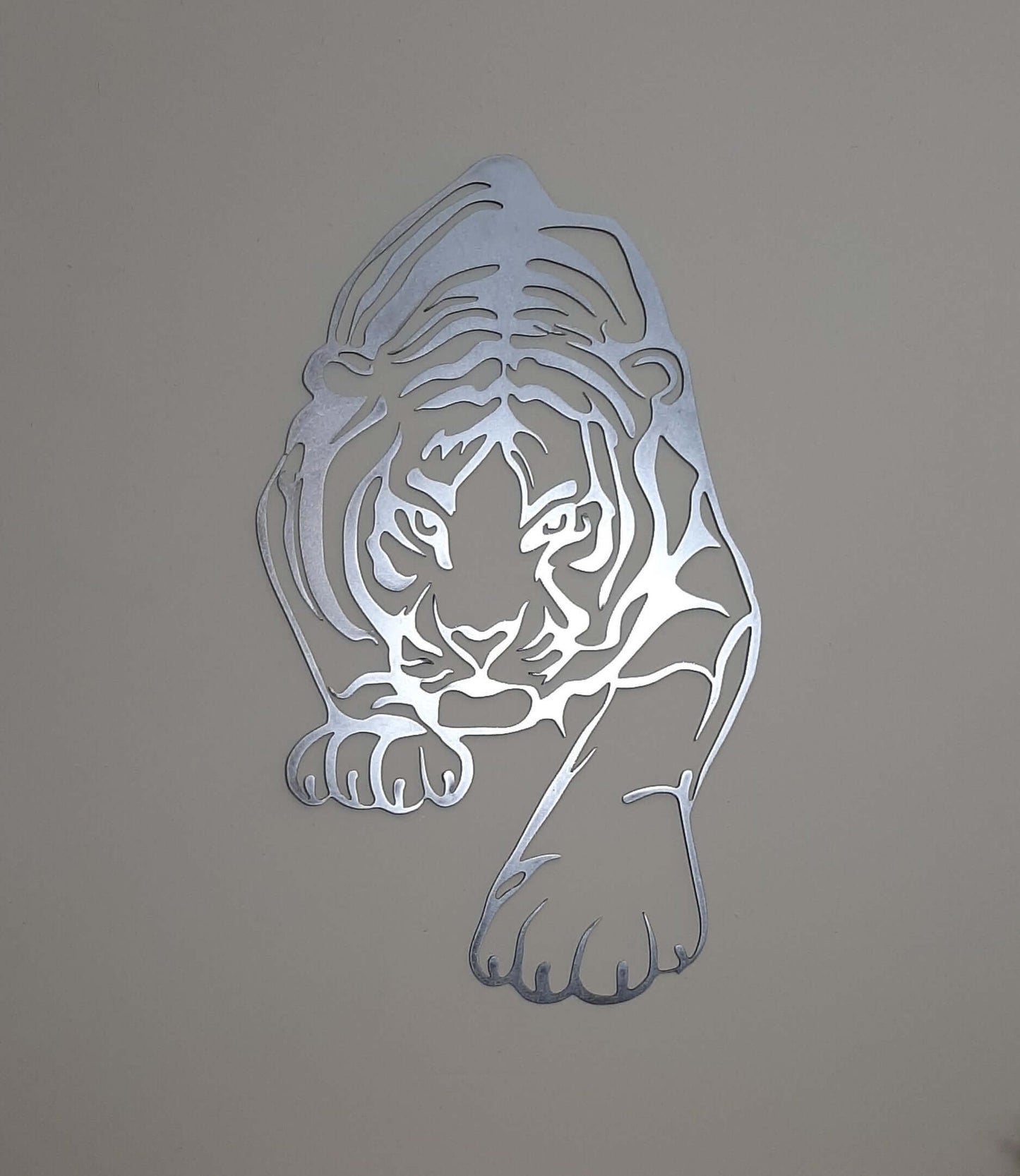 Contemporary metal tiger wall art on textured beige wall