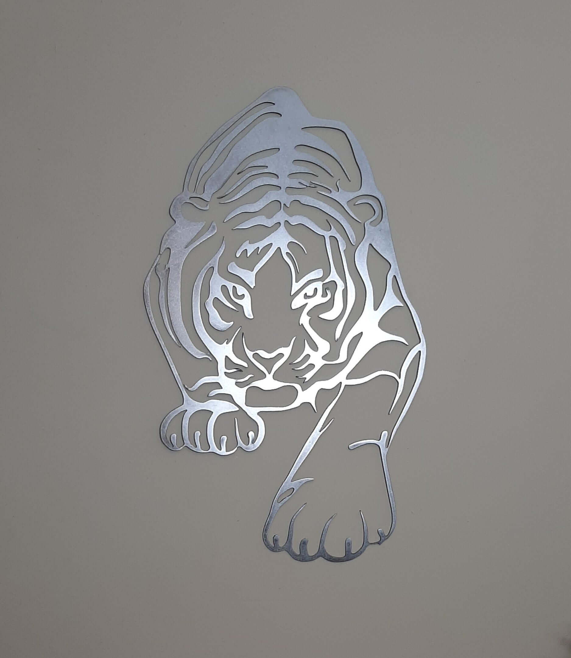 Contemporary metal tiger wall art on textured beige wall