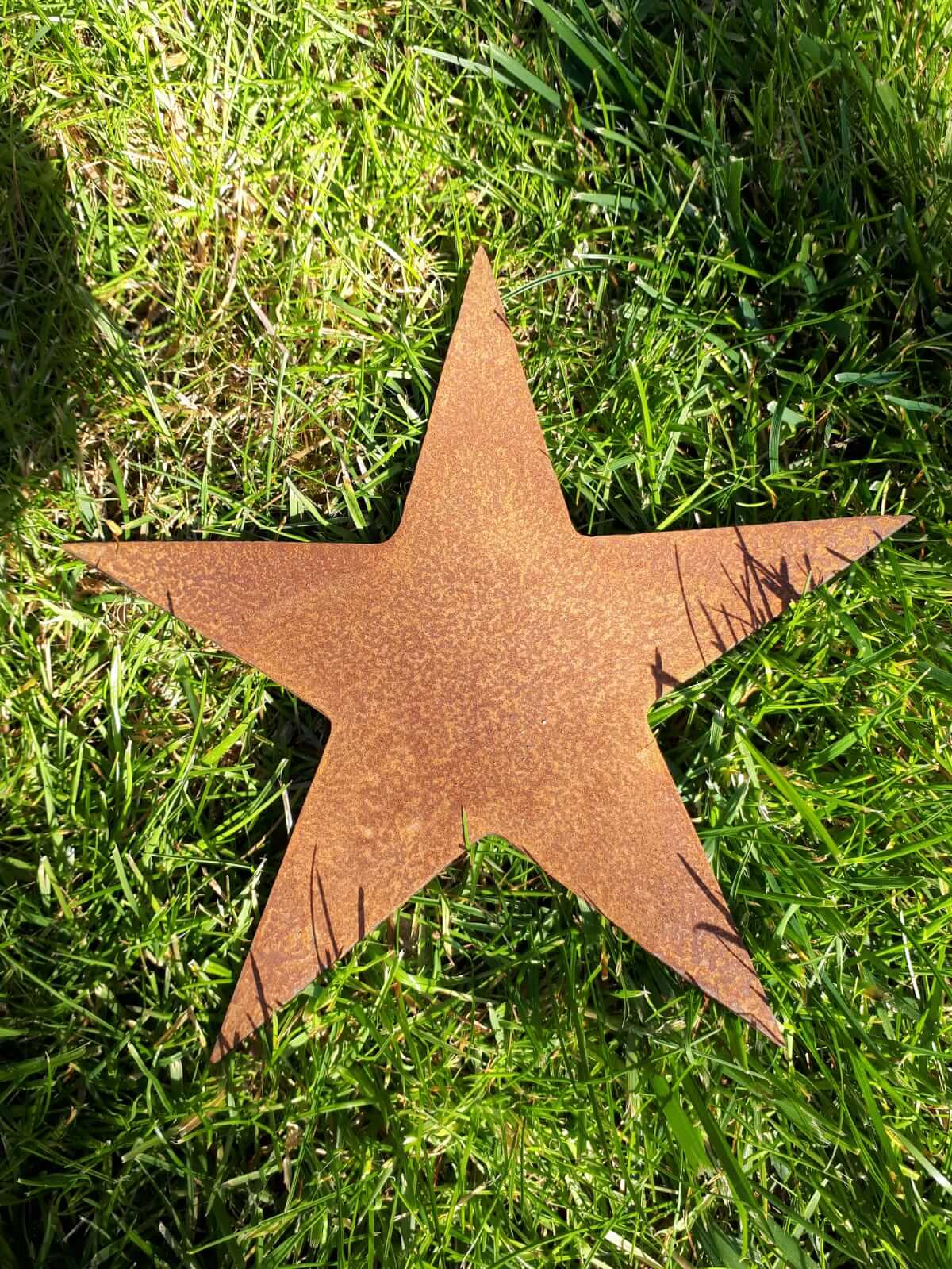 Rustic Steel Star Garden Gift Set - Medium rusty metal star garden ornament displayed on lush green grass