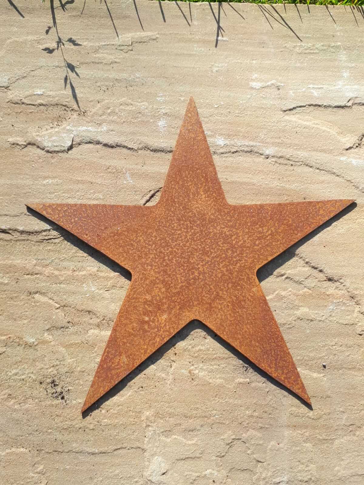 Rustic Steel Star Garden Gift Set - Medium metal Rusty star garden ornament on a stone background
