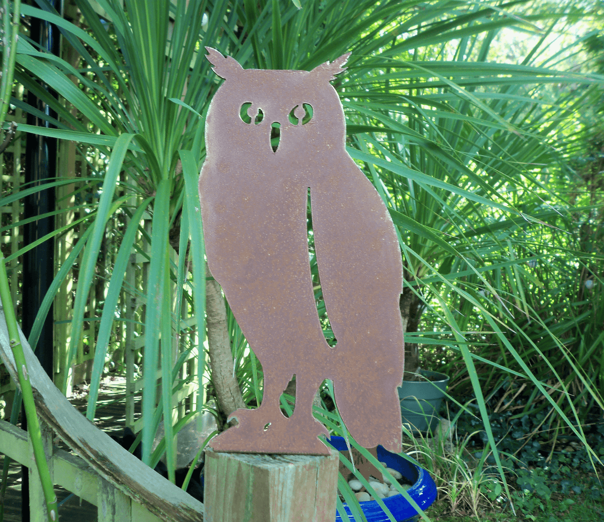 Rustic Steel OWL Garden Ornament displayed in a garden, showcasing its unique rusted finish and rustic charm.