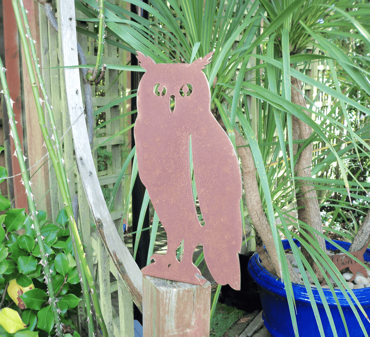 Rustic Steel OWL Garden Ornament displayed beside plants as a unique garden decoration.