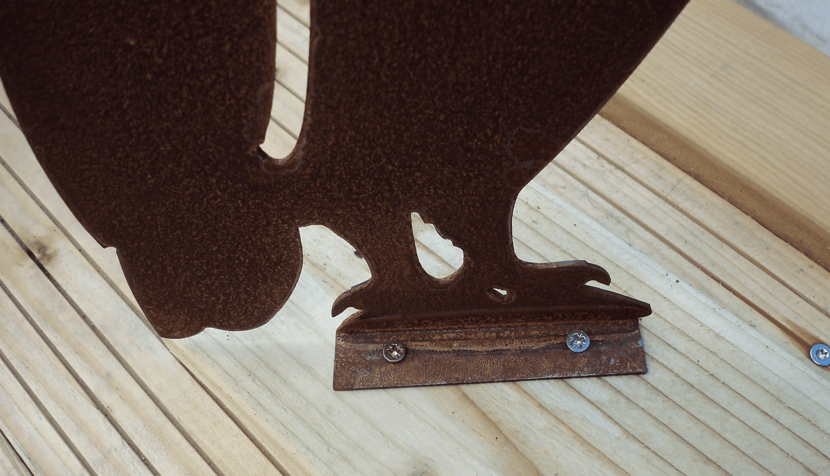 Close-up of the base of Rustic Steel OWL Garden Ornament, showcasing the unique rusted finish and mounting details.