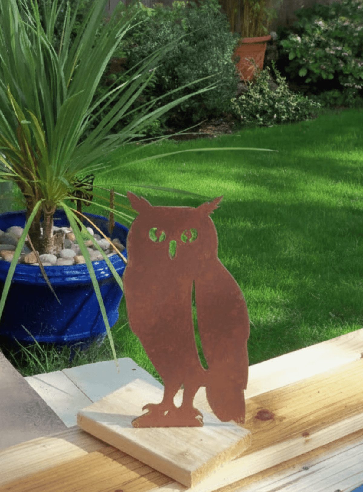 Rustic Steel OWL Garden Ornament displayed in a garden with green grass, showcasing its unique rusty finish.
