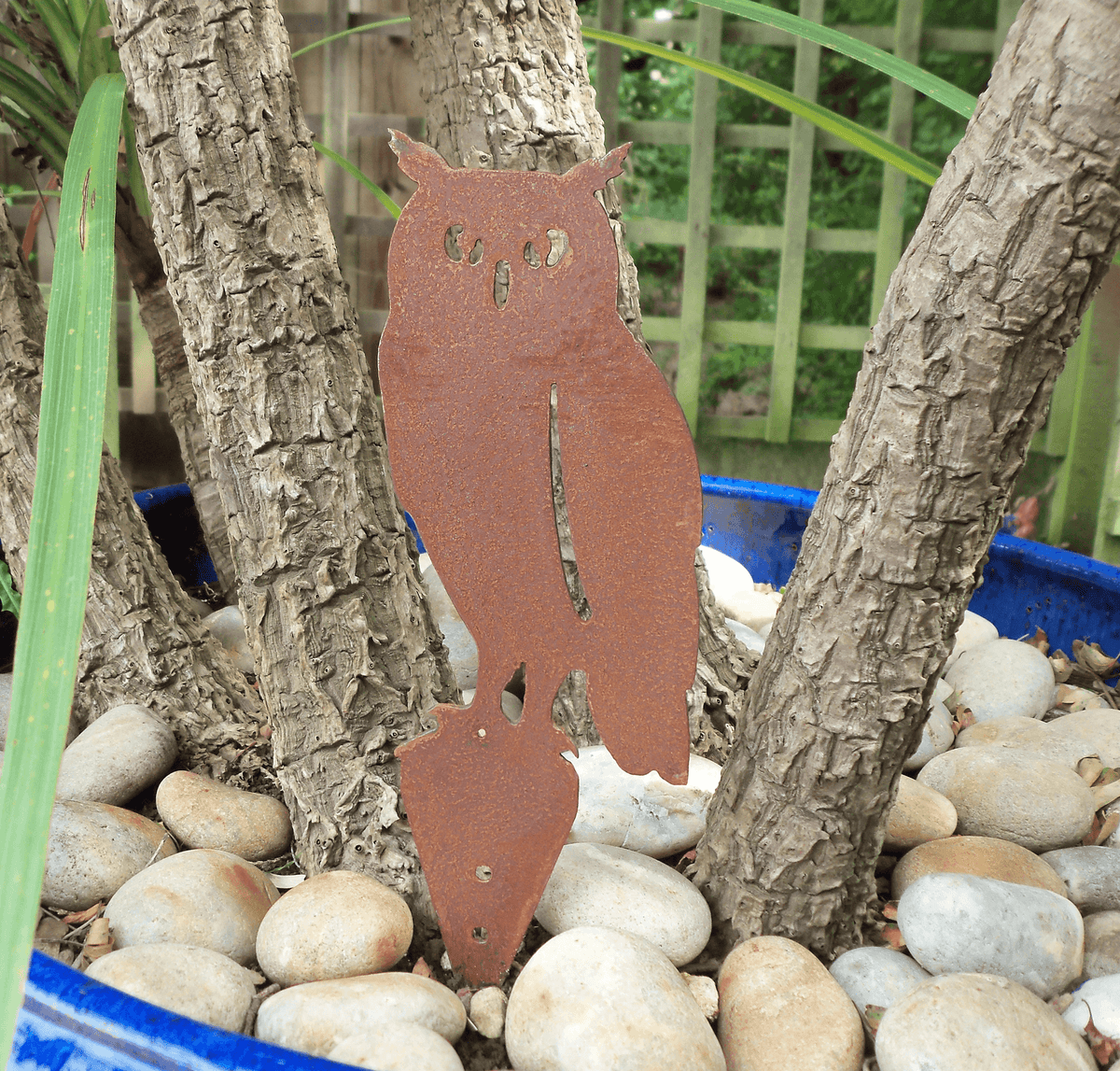 Rusted Steel OWL Garden Ornament in a planter with stones, showcasing rustic charm and unique patina finish.