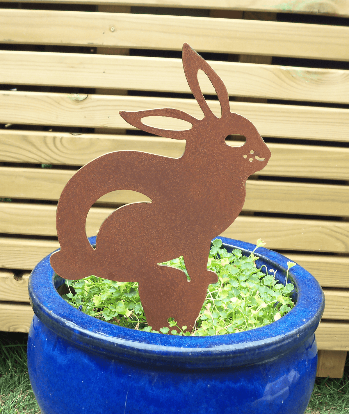 Rusted Steel RABBIT Garden Ornament in blue pot, showcasing unique rust patina - Rusty Steel Rabbit Garden Ornament for garden decor.