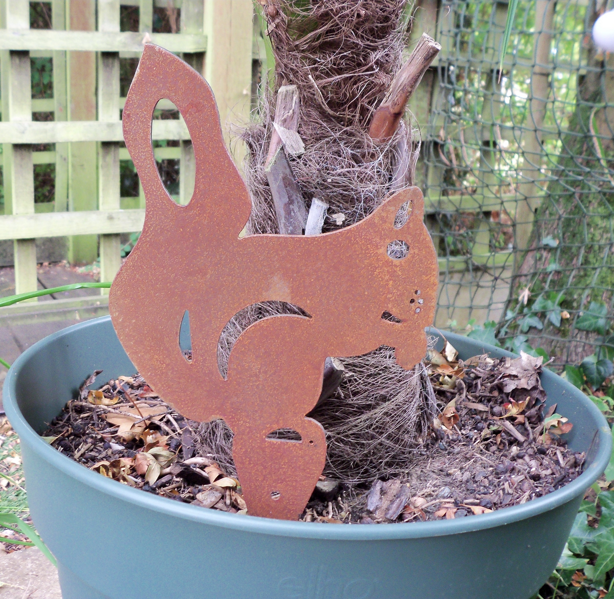 Rusty Steel Squirrel Garden Ornament in a pot, showcasing unique rusted metal garden art for outdoor decor.