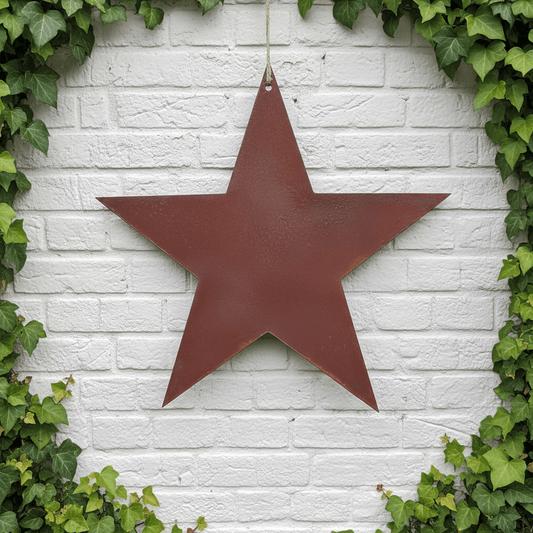 Rusty Metal STAR Garden Ornament decoration on a white brick wall background, with ivy around the sides