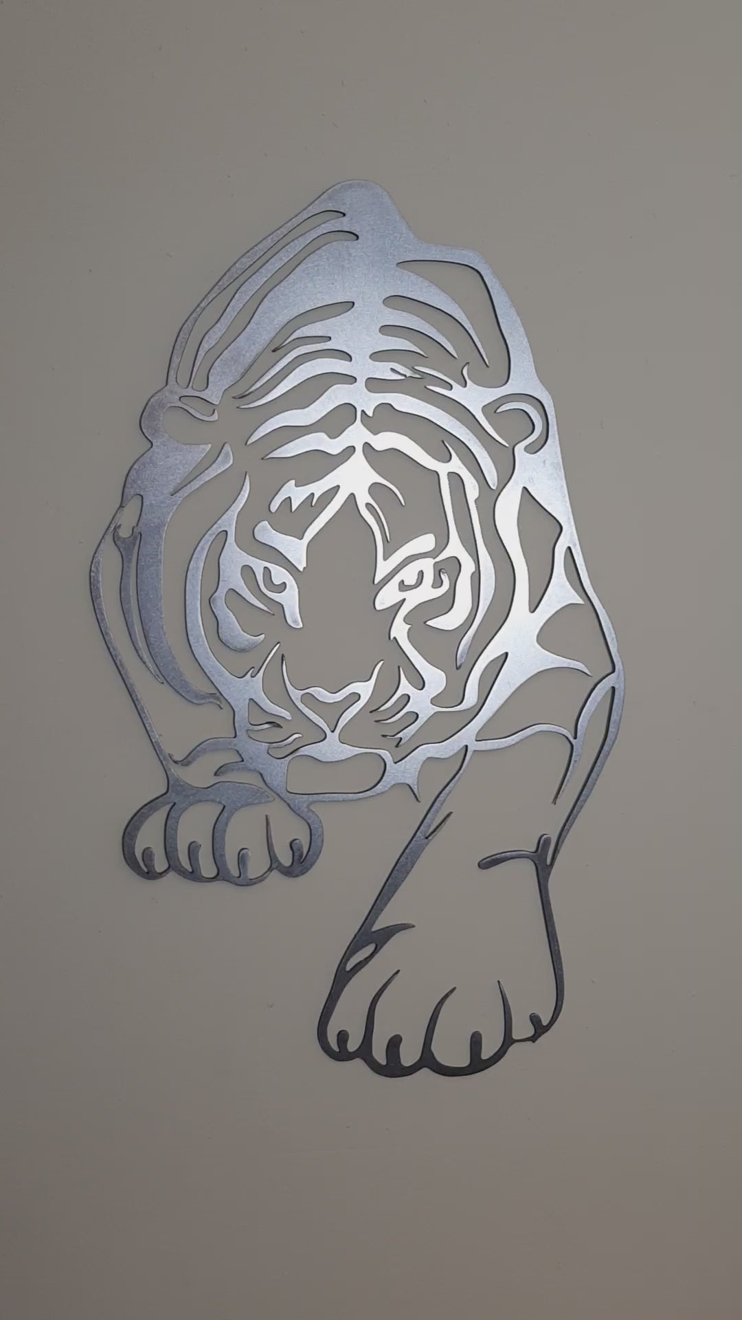 Statement metal tiger wall art decoration on a clean neutral-toned wall